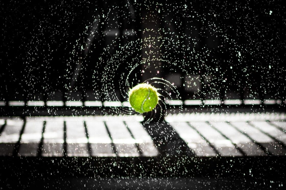 photo of tennis ball spinning with water