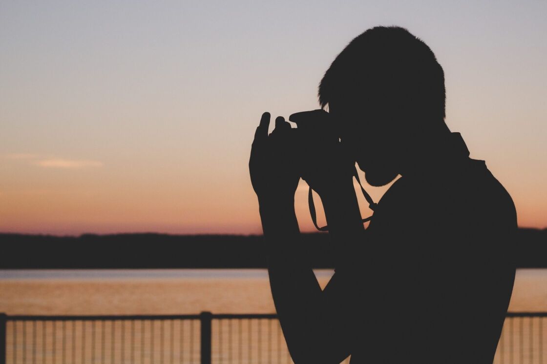image of silhouette of person using camera