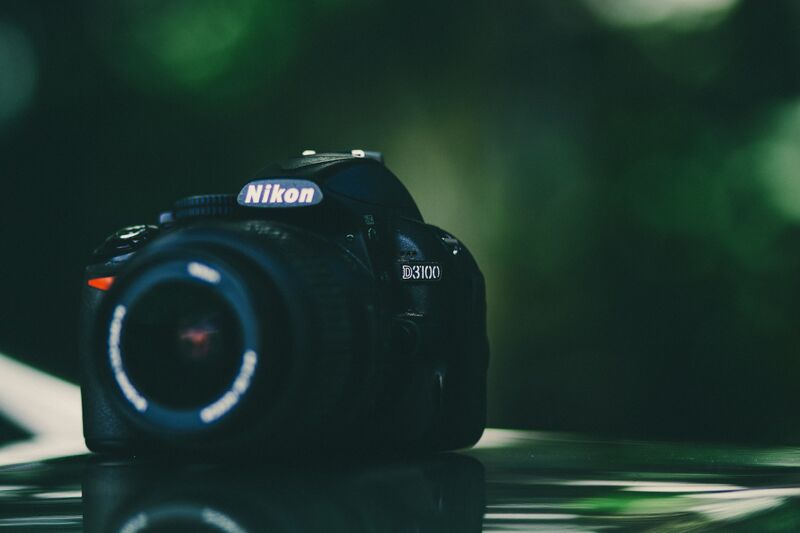 image of nikon d3100 against a green background