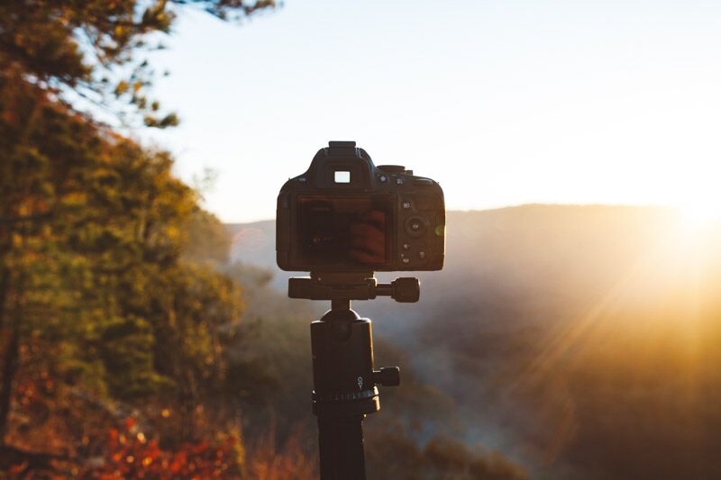 image of camera on a tripod at sunset