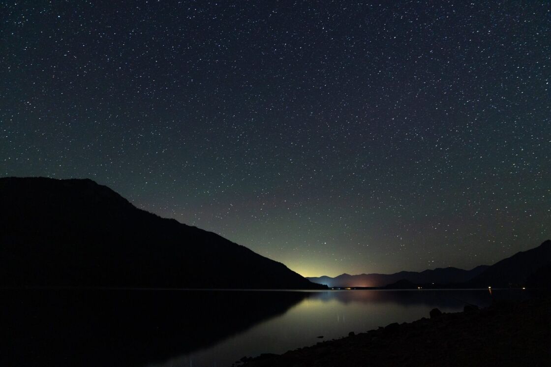 image of night sky with stars over a lake