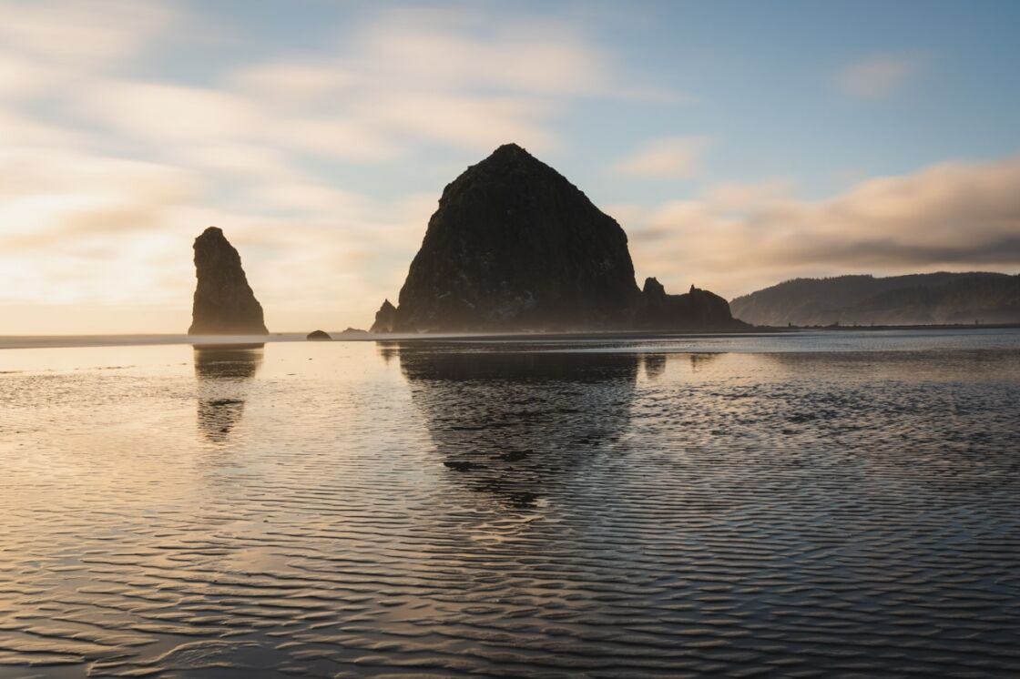 image of cannon beach haystack at sunset with clouds