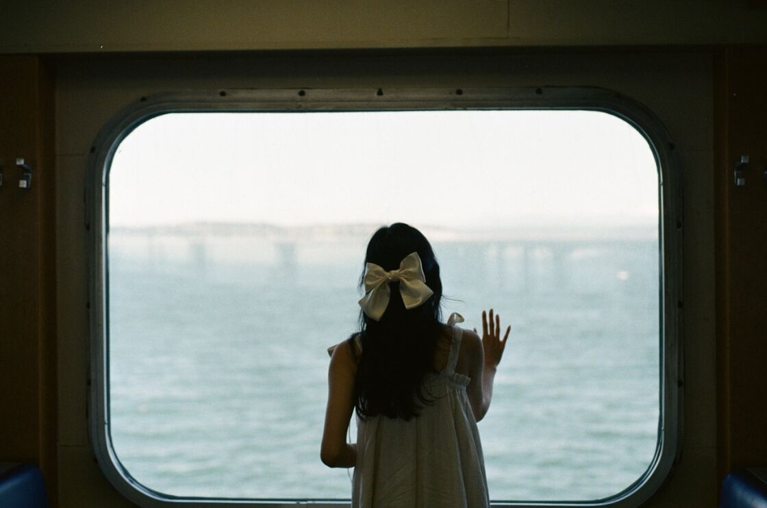 image of girl looking out of ferry window